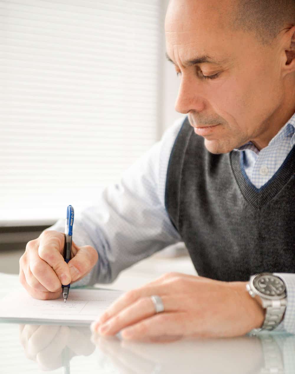 david-marcus-writing David Marcus writing on a notepad on a desk
