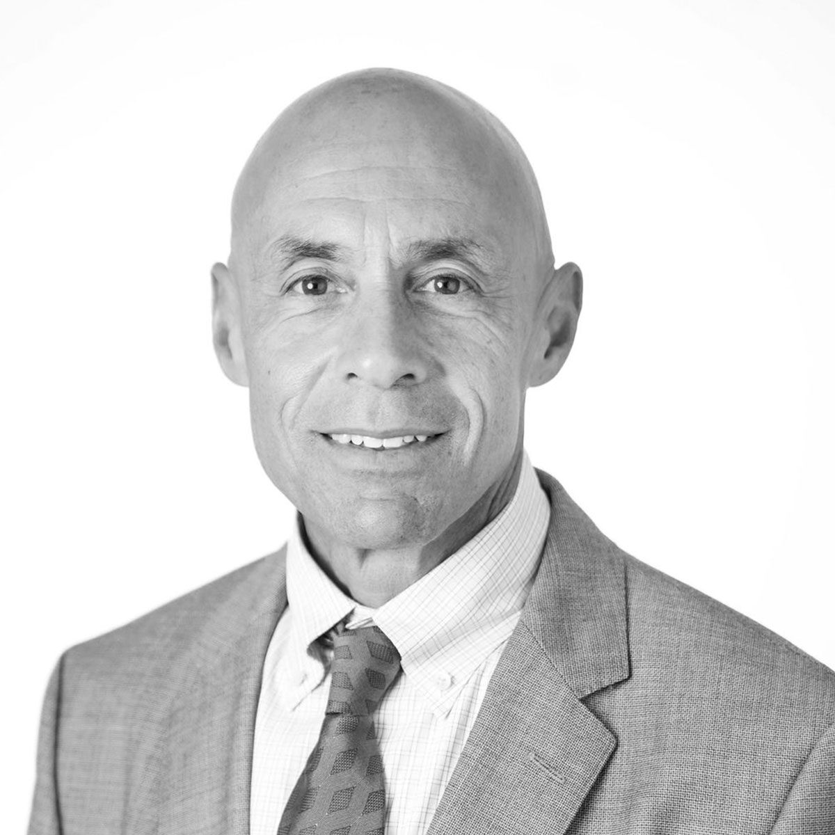 resized-david-marcus David Marcus of DLM law wearing a suit, dress shirt, and patterned tie, facing forward and smiling slightly against a plain white background.